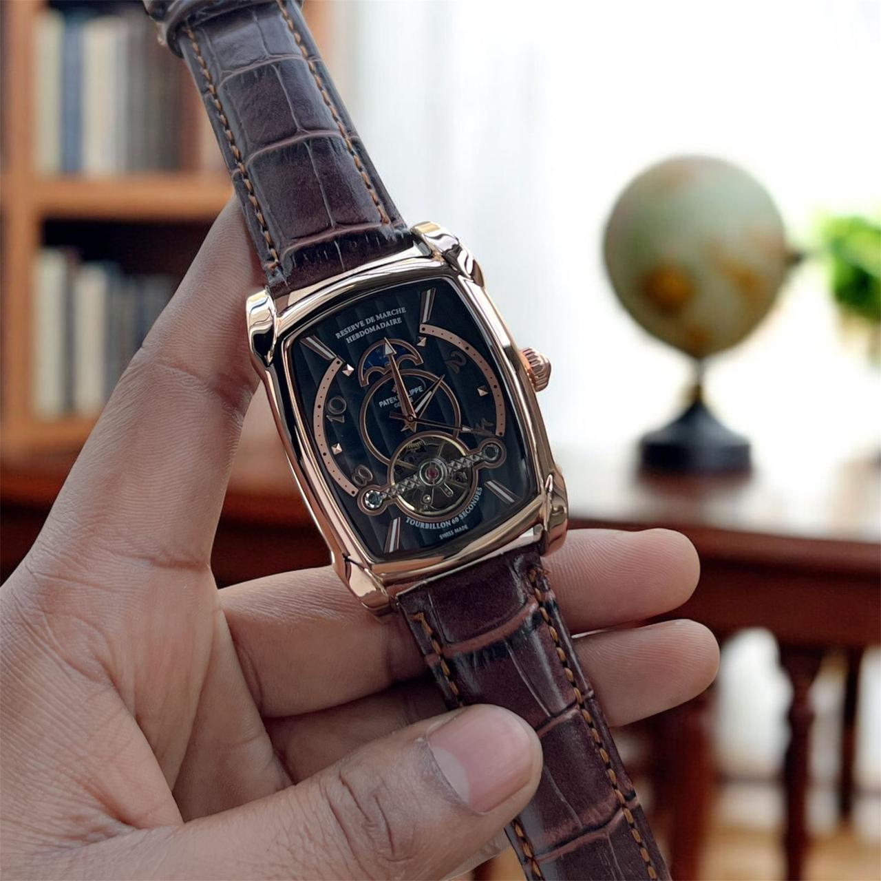 Patek Philippe Tourbillon with rose gold case, moonphase detail, and premium leather strap